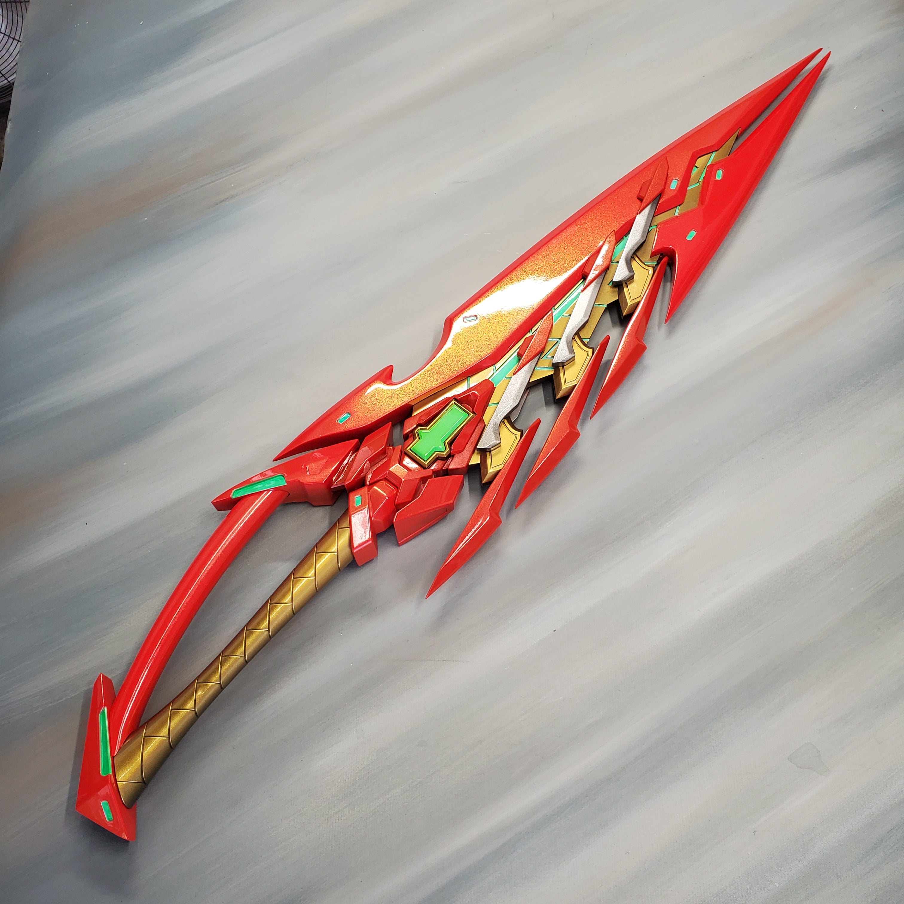 Red and gold fantasy spear on a gray background