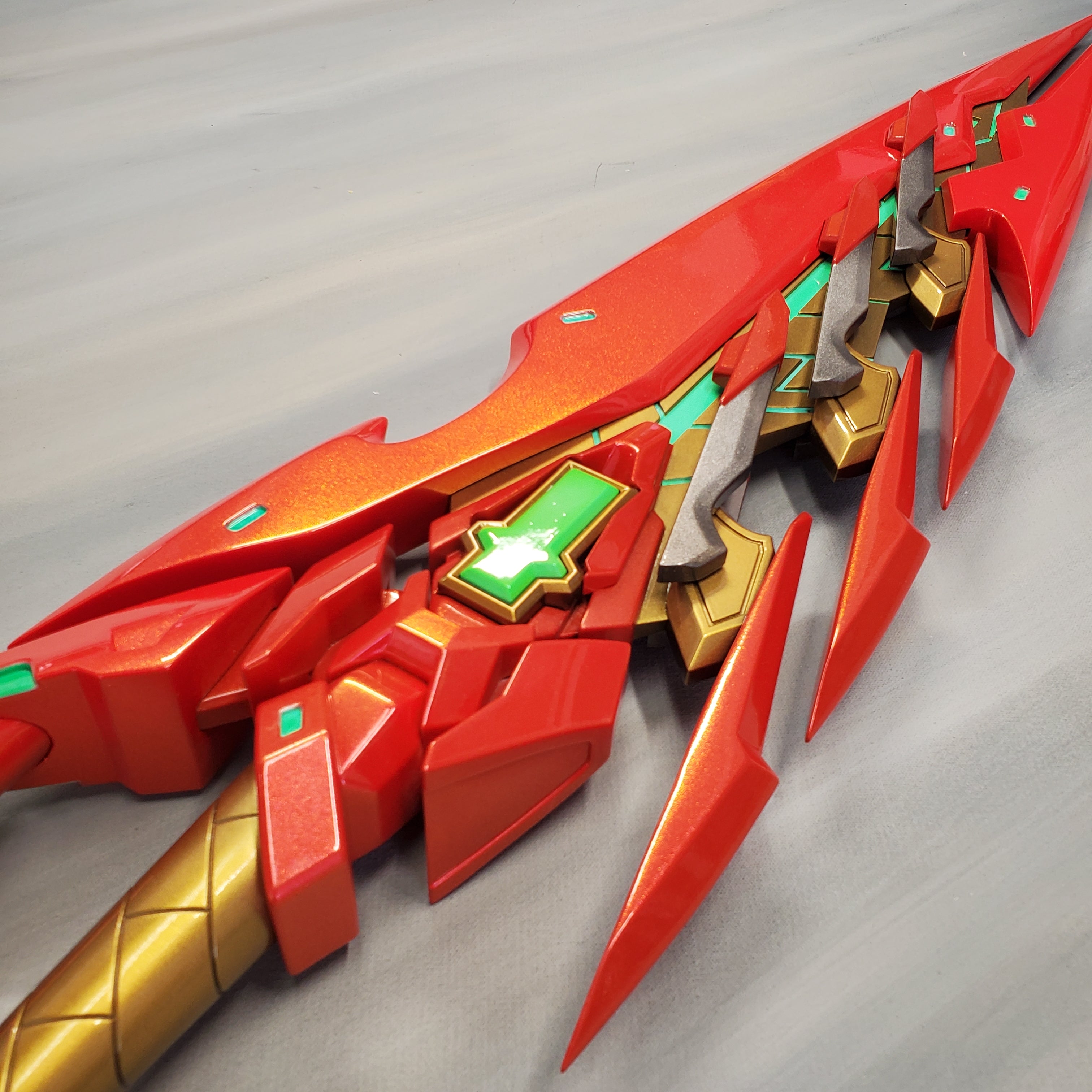 Red and gold futuristic weapon on a gray background