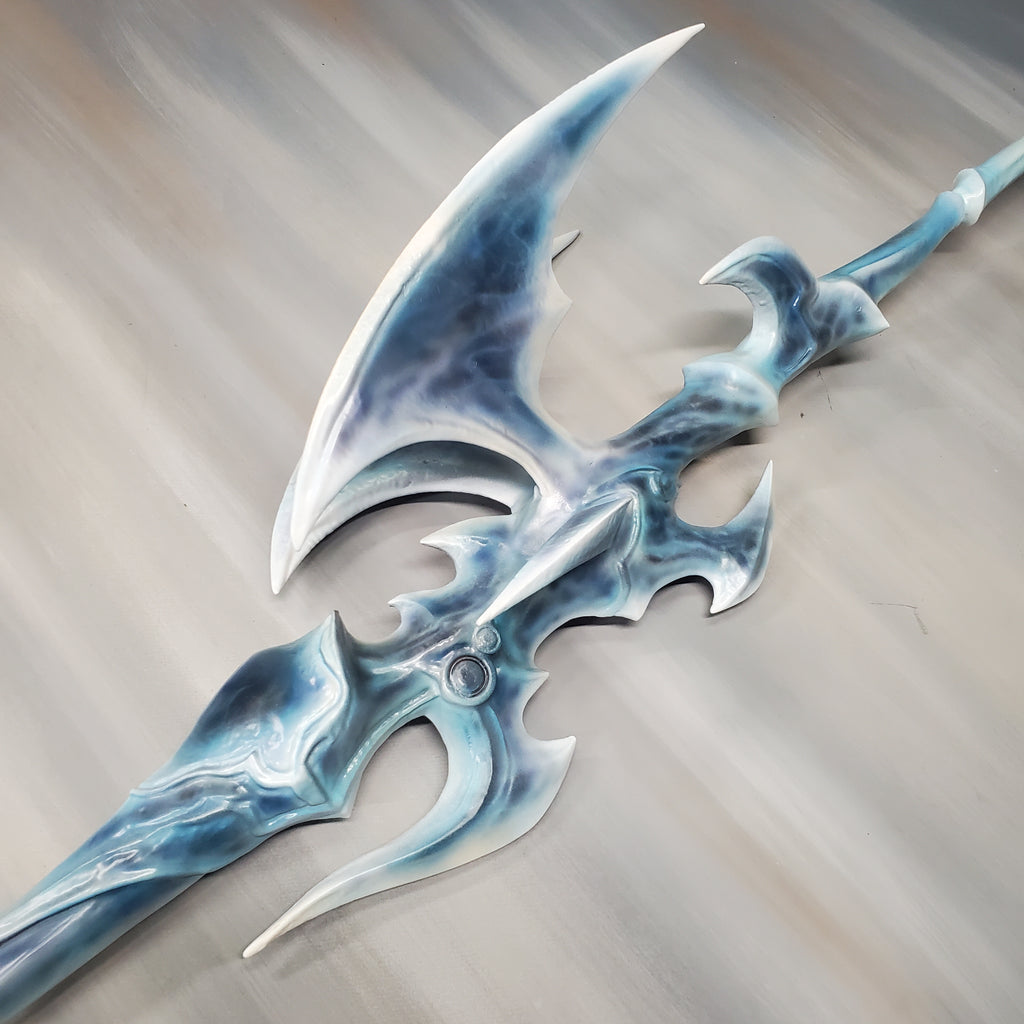 Decorative axe with blue and silver design on a neutral background
