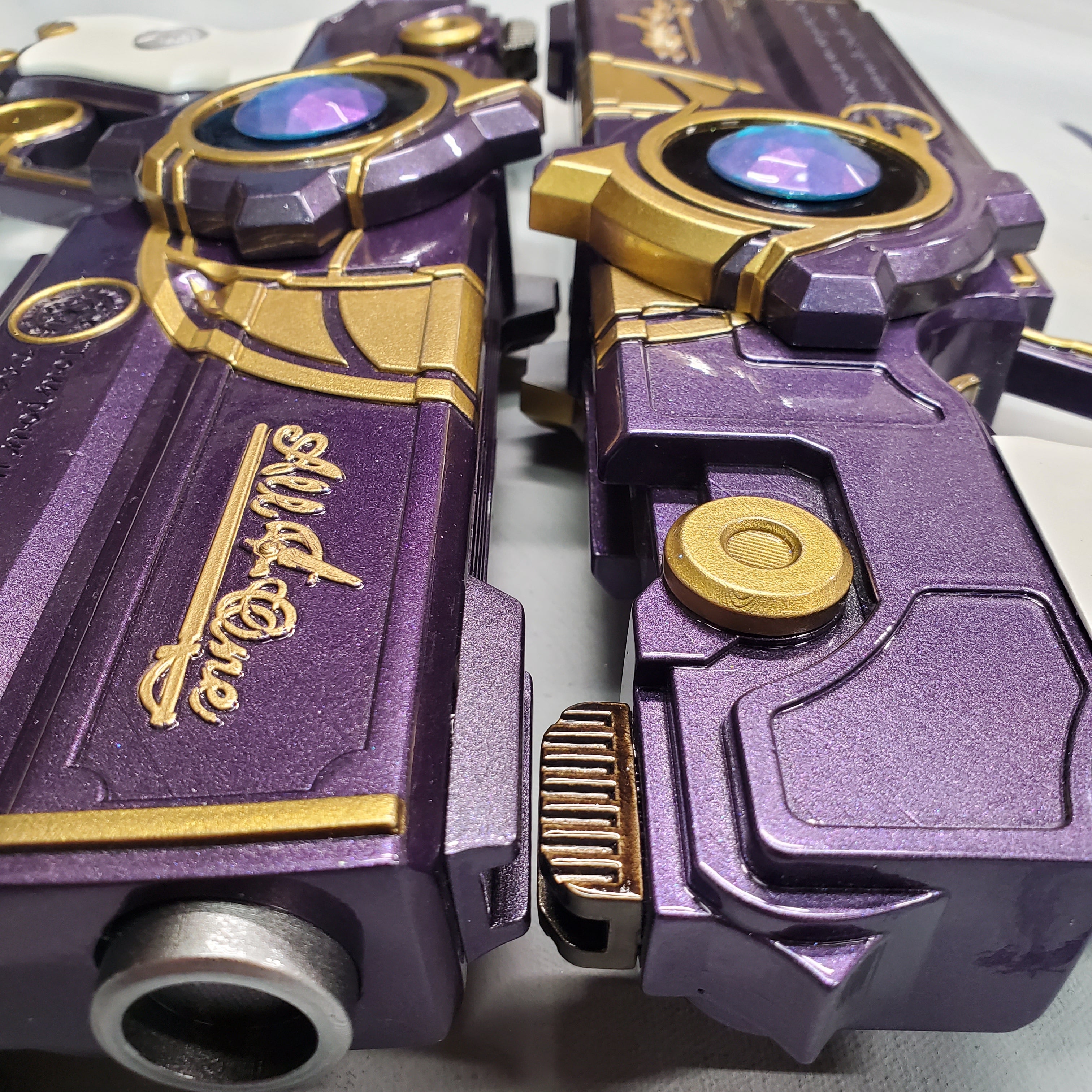 Close-up of a purple and gold robot toy with 'All in One' branding.