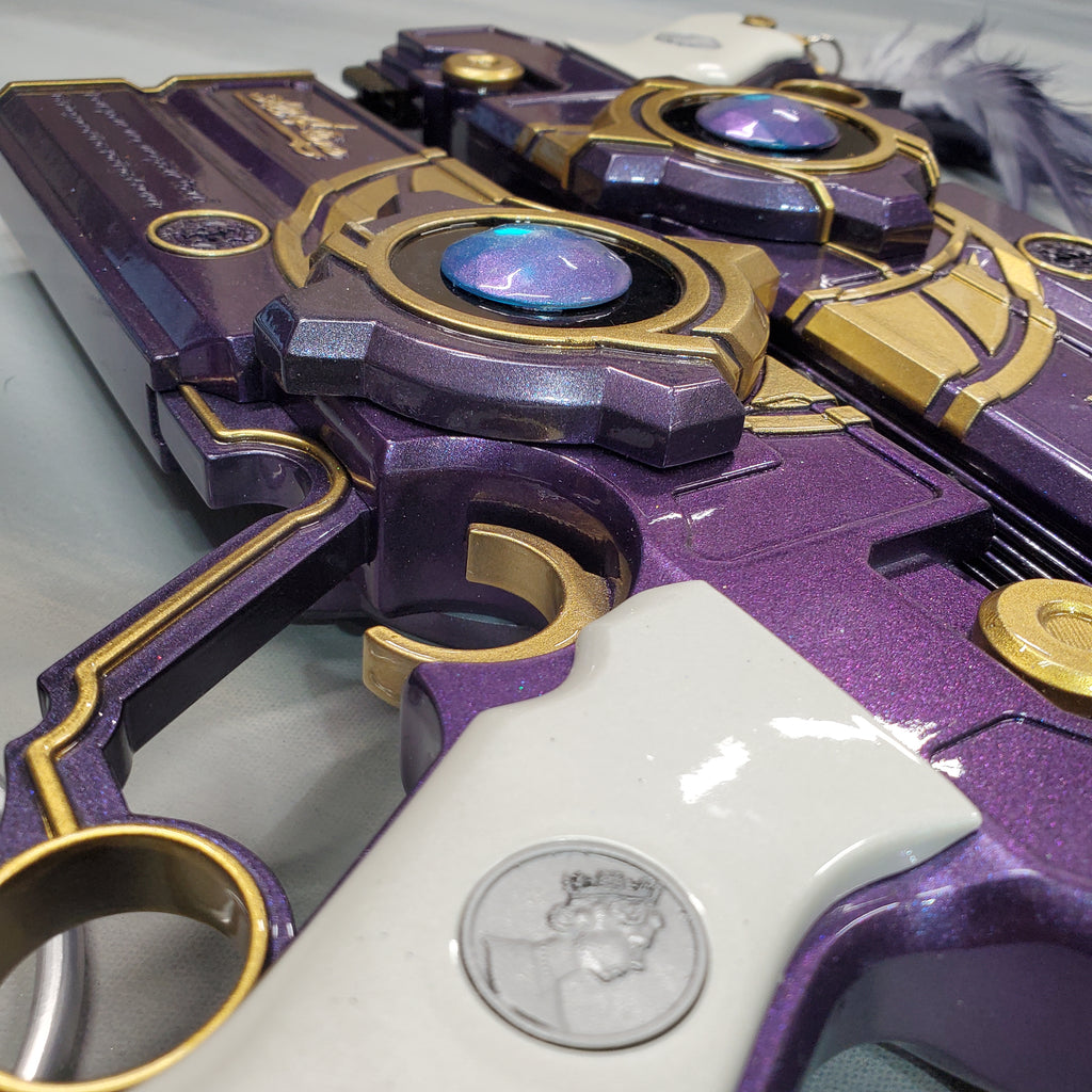 Close-up of a purple and gold toy gun with intricate design