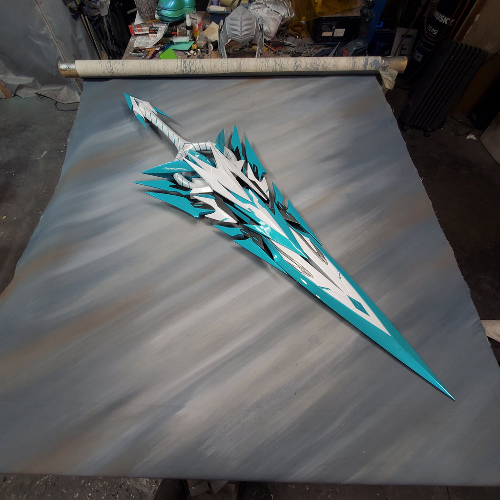 Decorative sword with blue and white design on a metallic surface