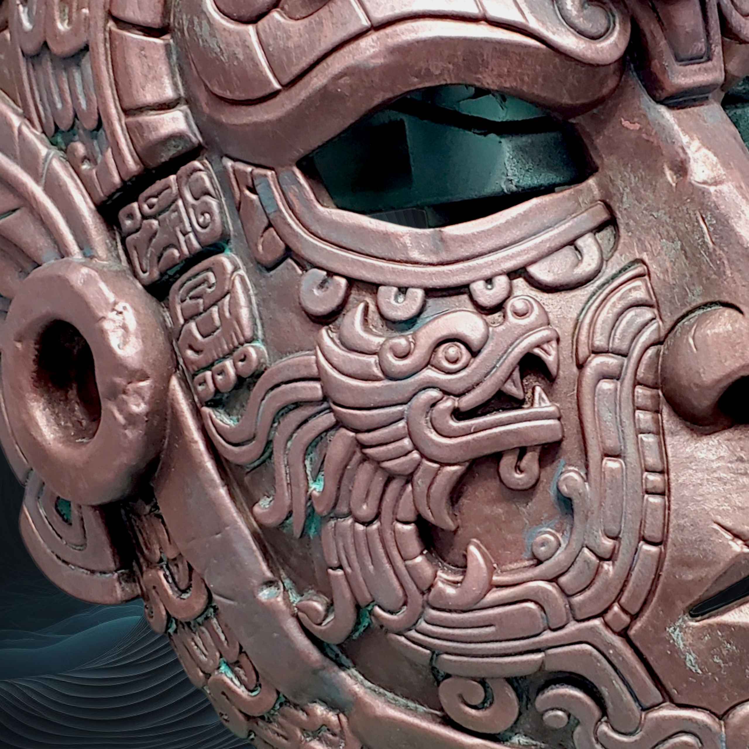 Close-up of a detailed metallic mask with intricate designs and textures.