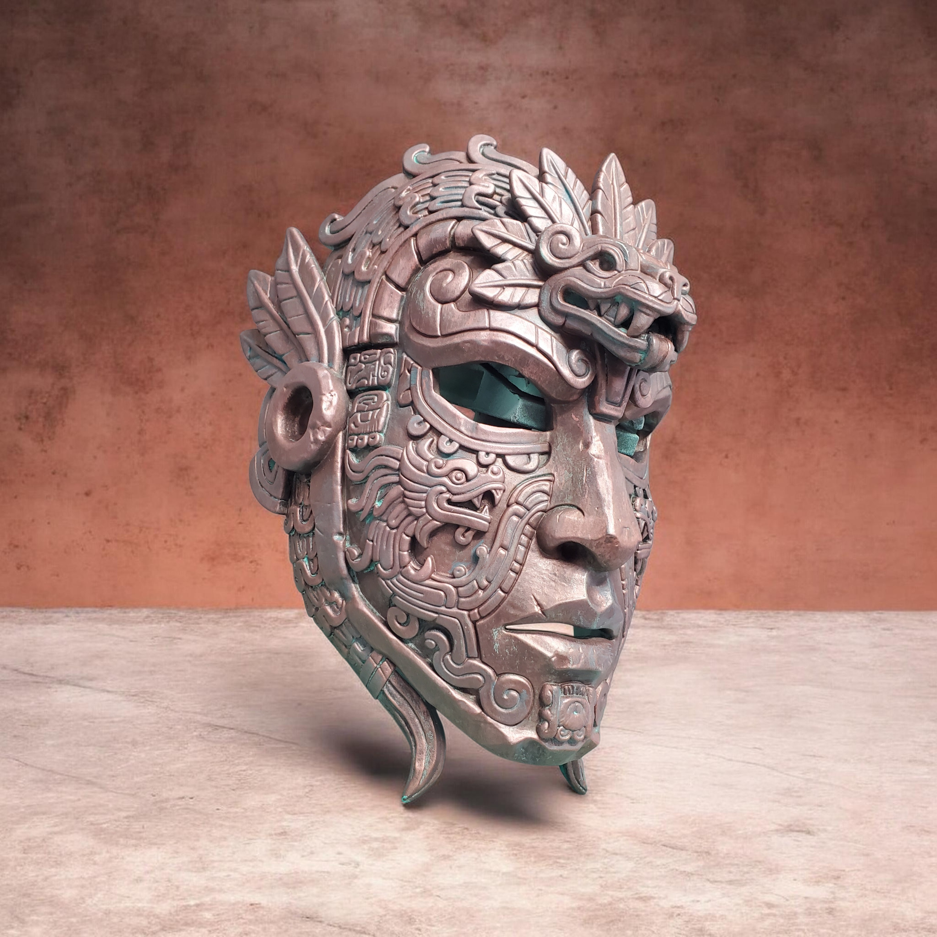 Decorative mask with intricate designs on a wooden surface and brown background