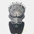 Silver mask with intricate design on a white background