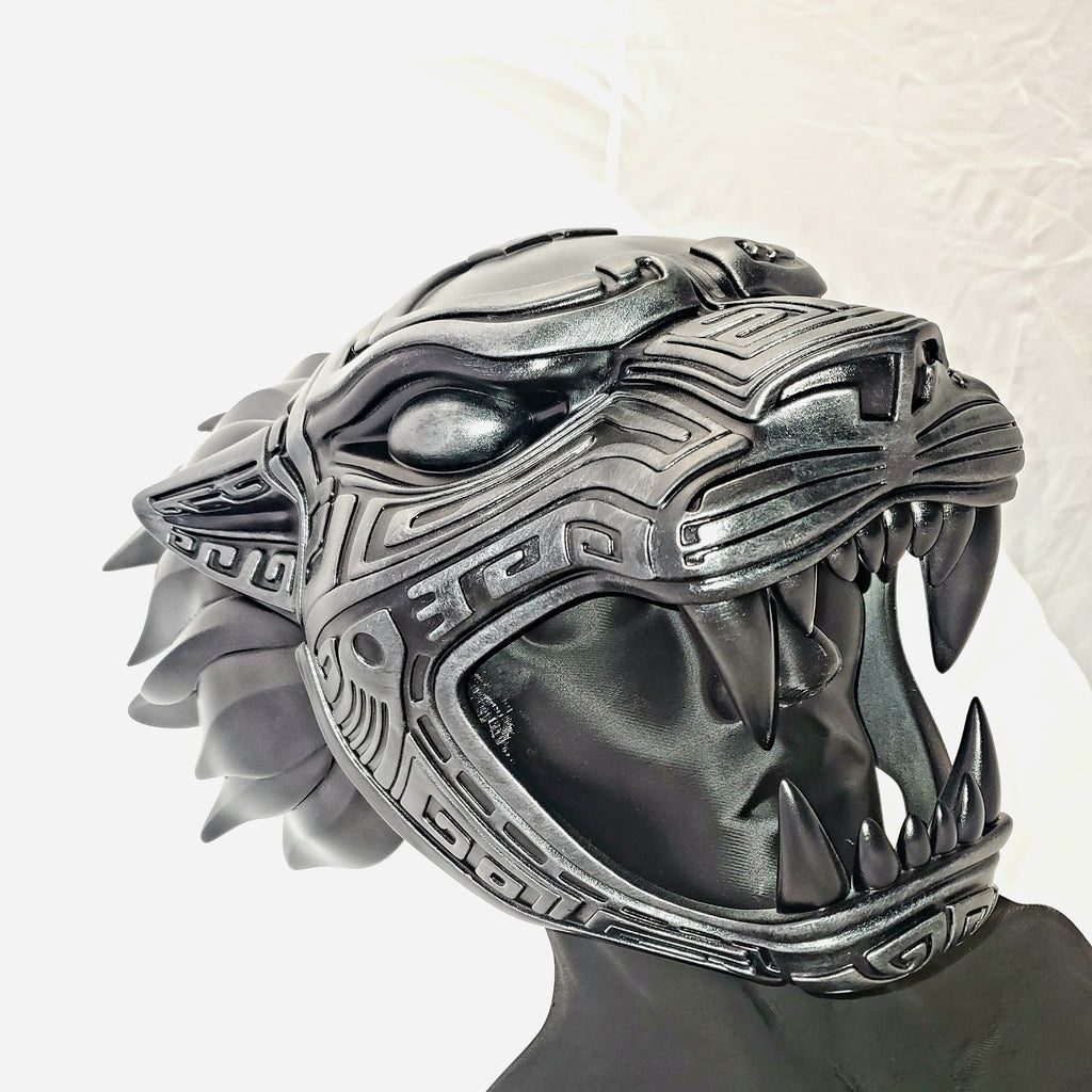 Silver panther head sculpture on a white background