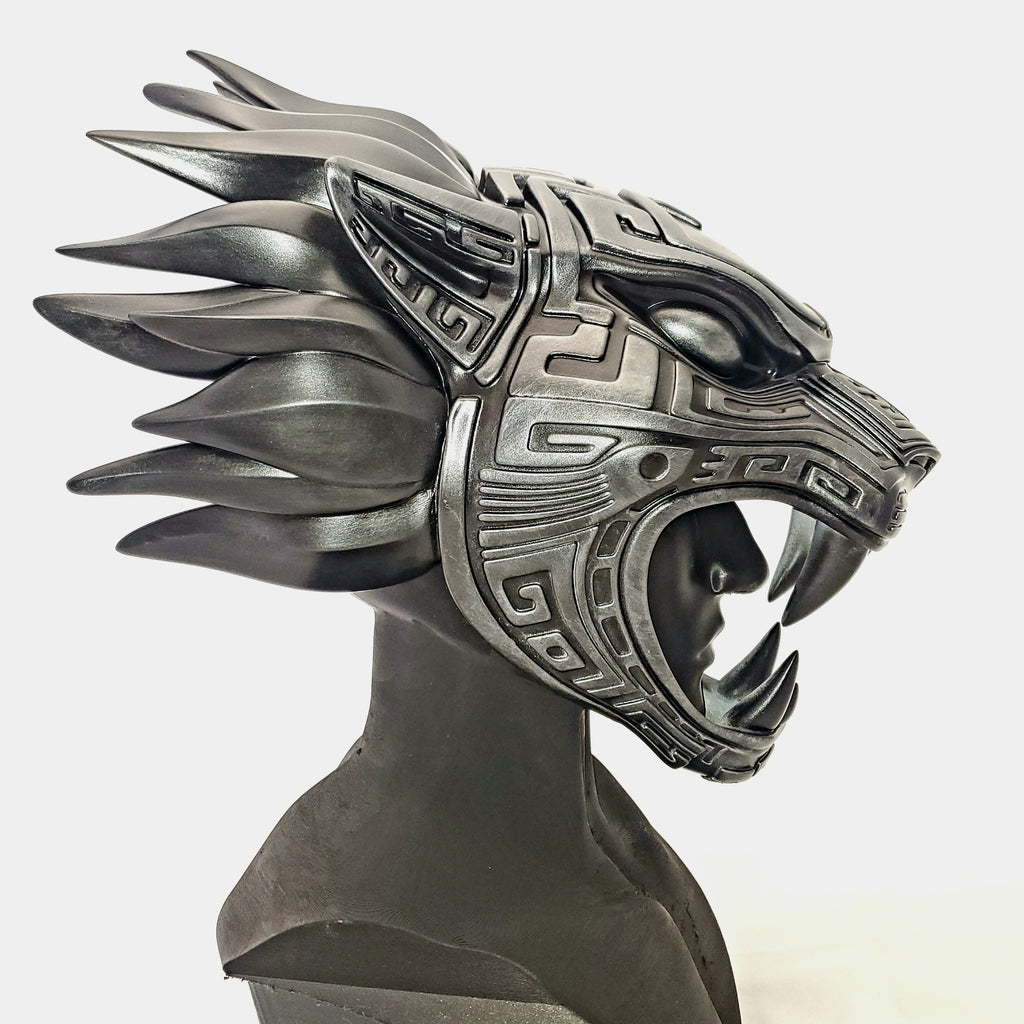 Metallic dragon helmet with intricate designs on a white background