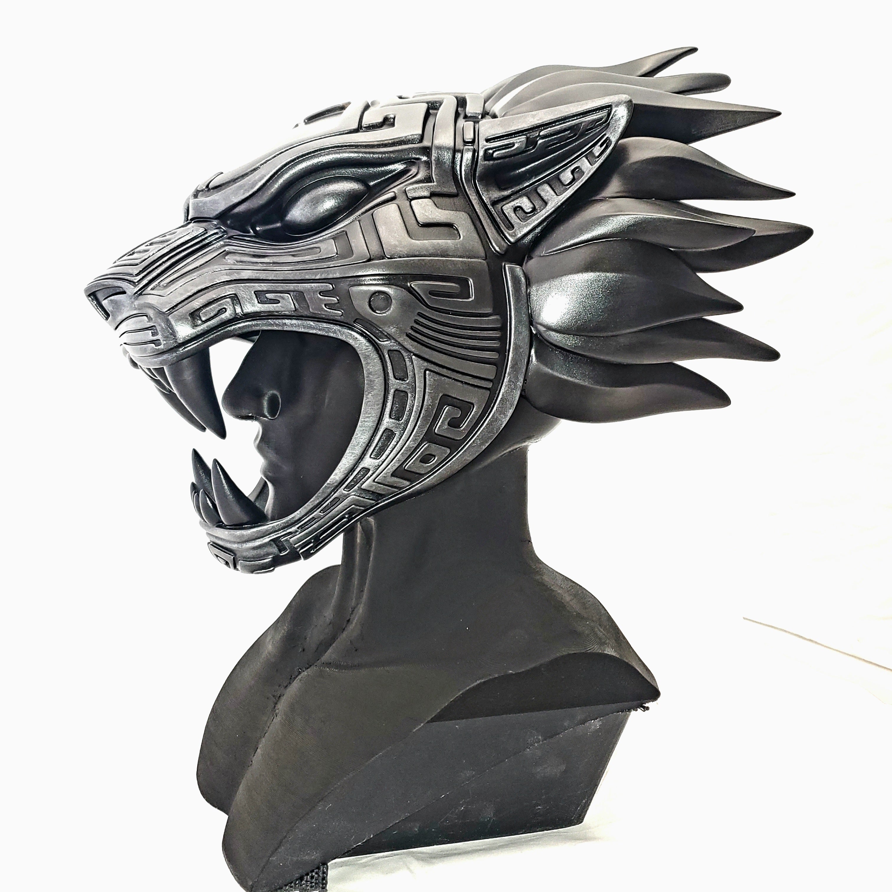 Decorative helmet with wolf design on a white background