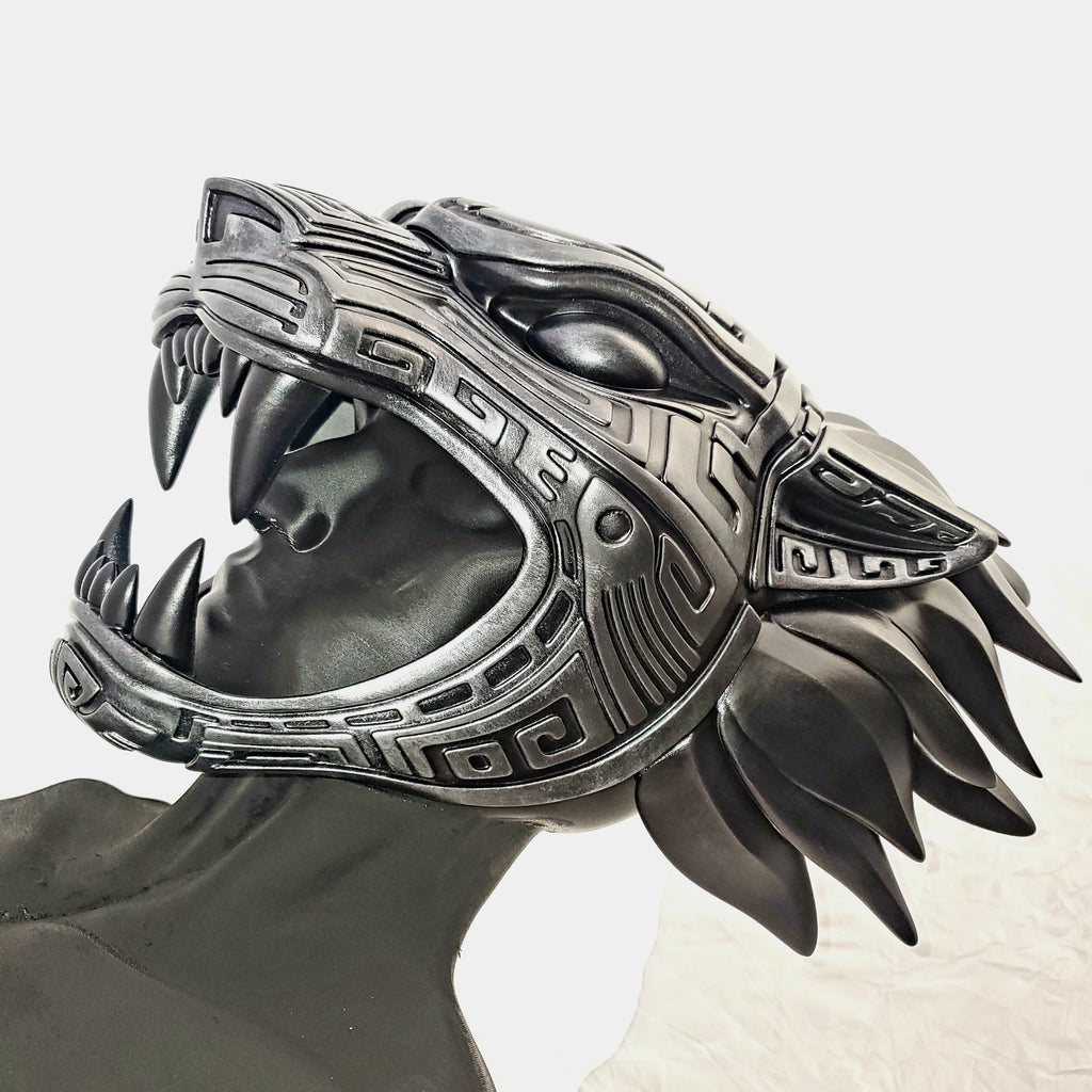 Metallic dragon head sculpture on a white background