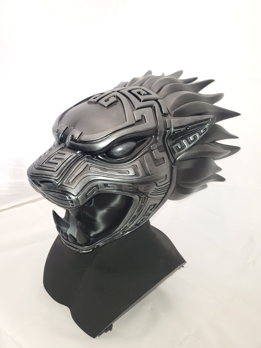 Black and silver helmet with intricate design on a white background