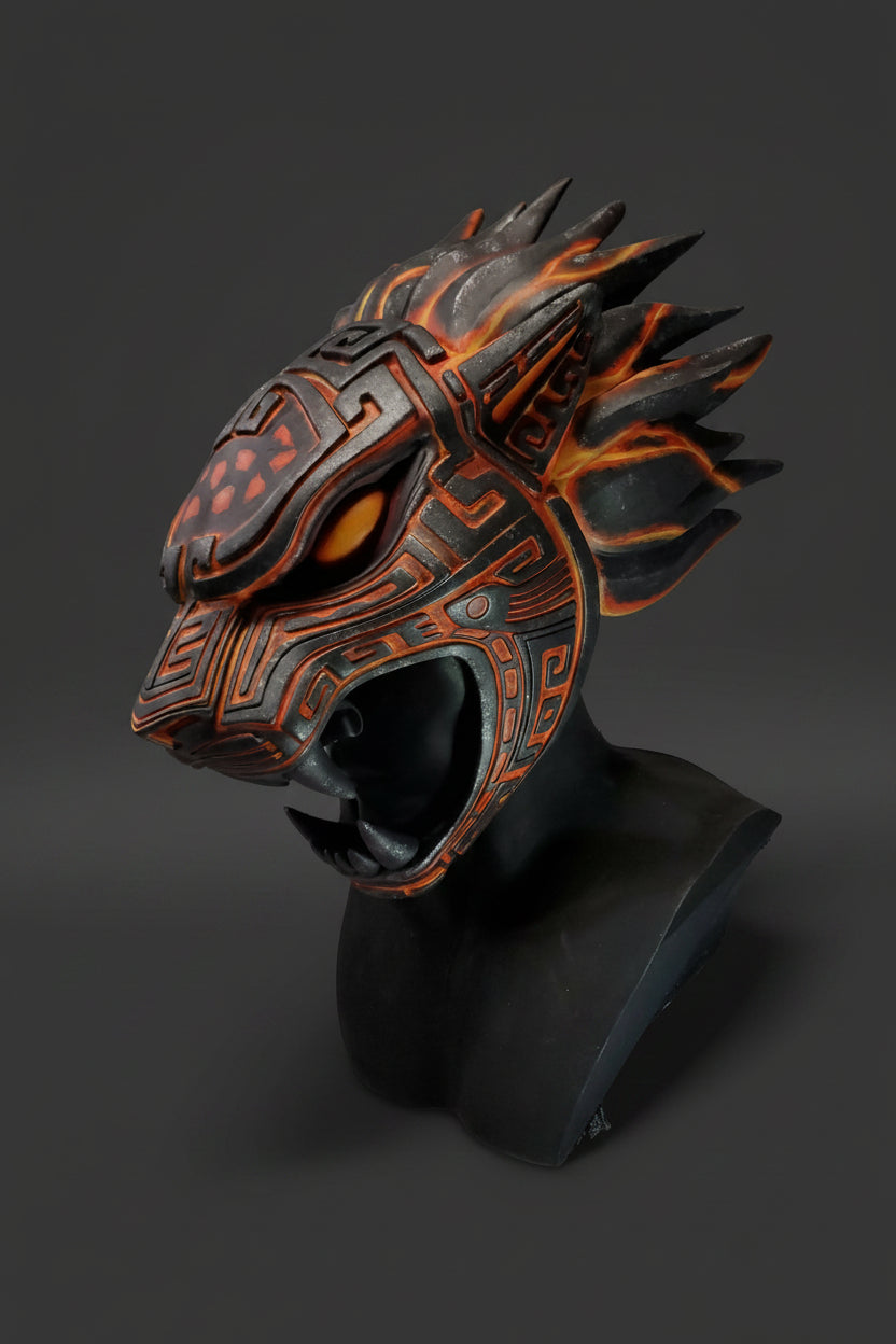 Decorative mask with orange and black design on a gray background