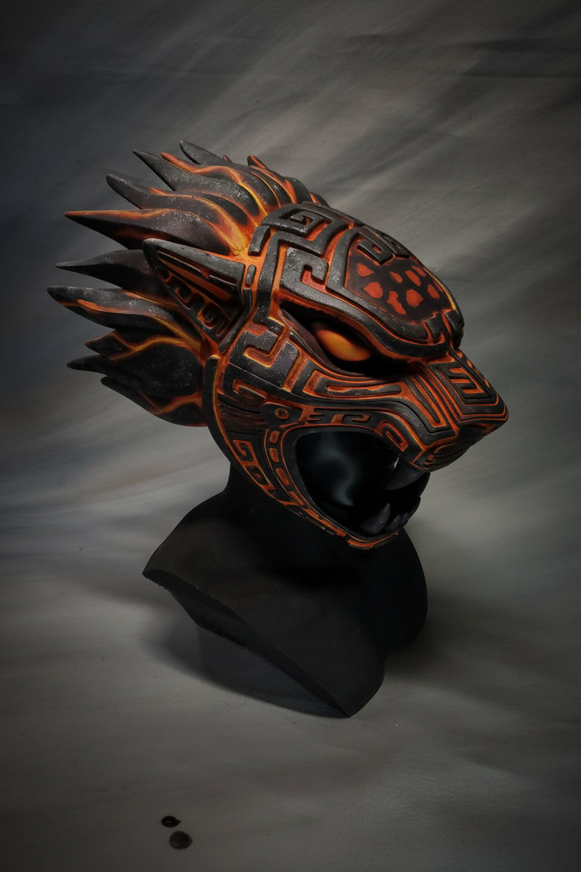 Decorative mask with intricate designs on a gray background