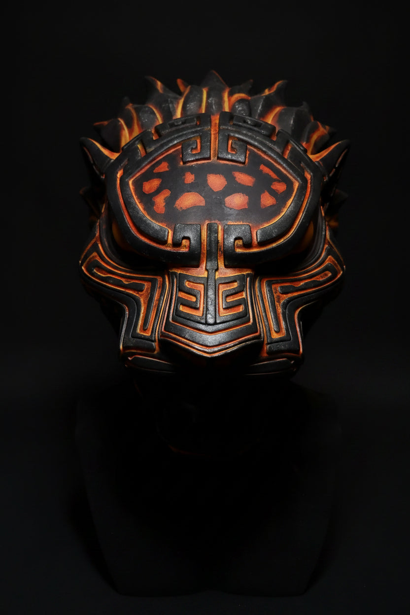 Decorative mask with intricate designs on a gray background
