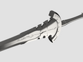 A close-up of a metallic fantasy sword hilt and part of the blade, shown on a plain light gray background. The blade has stylized engraved script and a curved guard.