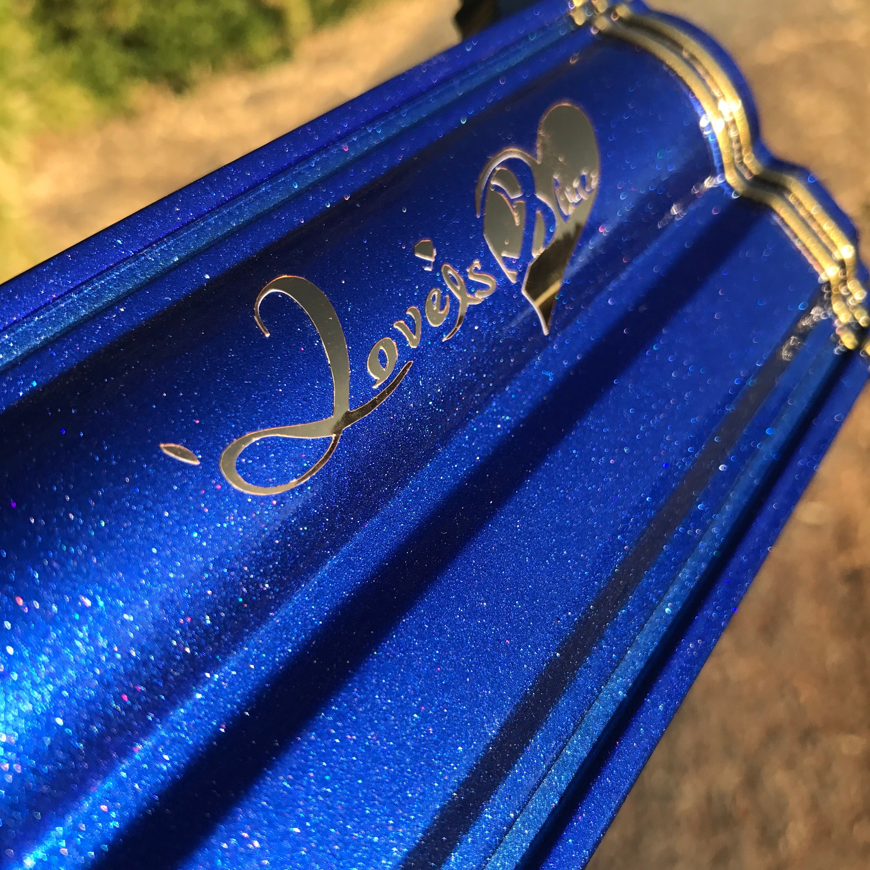 Blue glittery box with 'Jewel's' logo on a blurred natural background