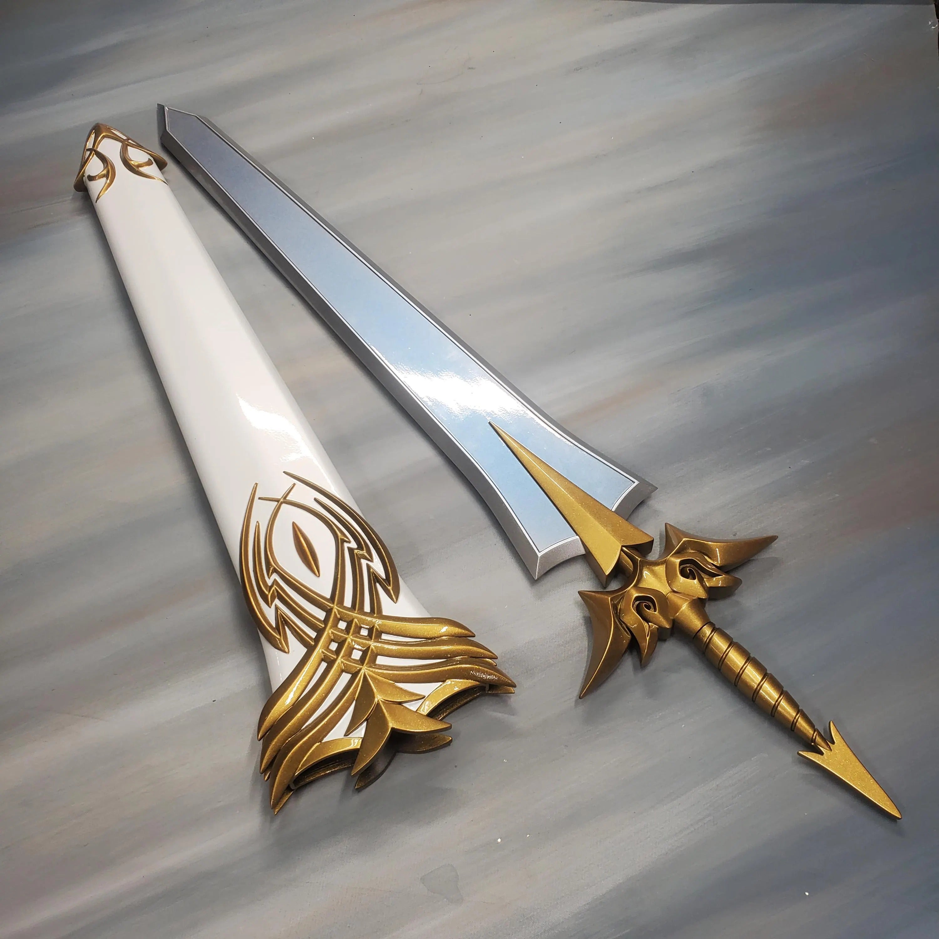 Decorative sword with gold and white sheath on a gray background
