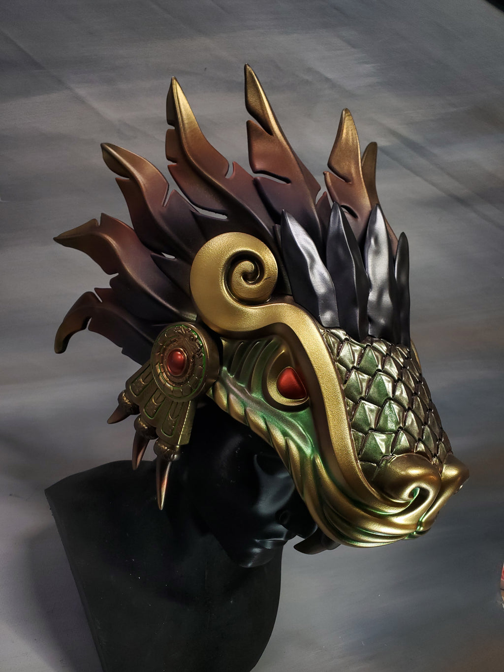 Decorative mask with intricate designs on a gray background