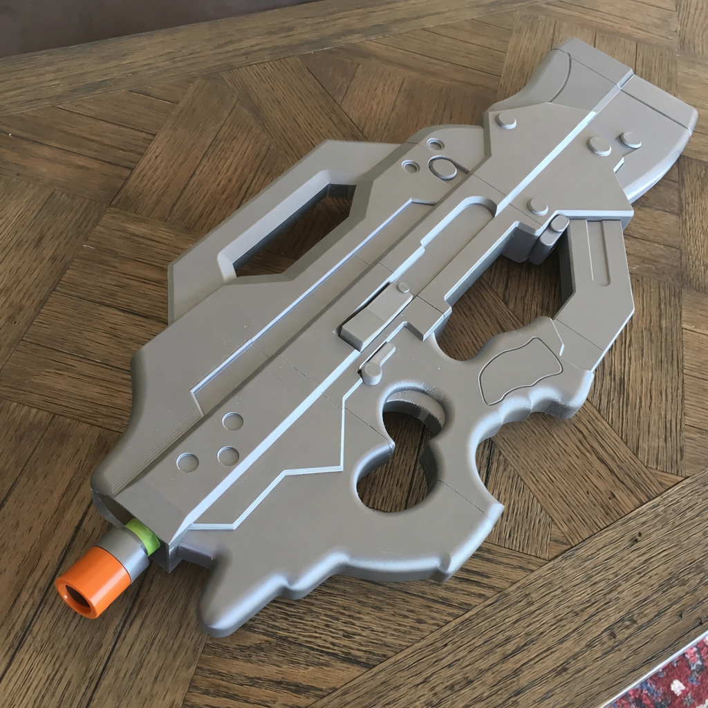 Toy gun with an orange tip on a wooden floor
